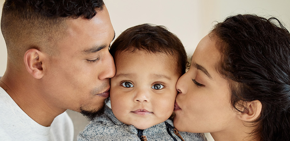 couple kissing baby