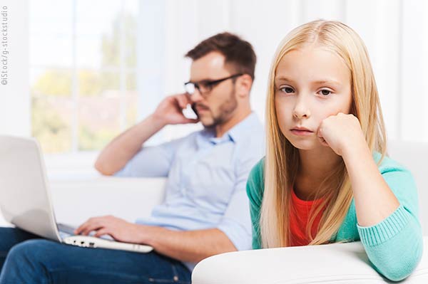 Father on cell phone ignoring daughter