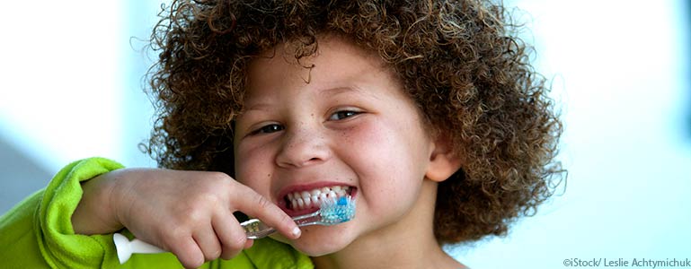 little girl brushing her teeth