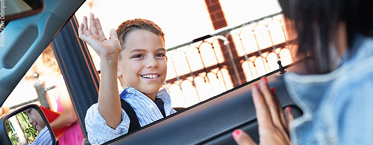 boy being dropped off at school