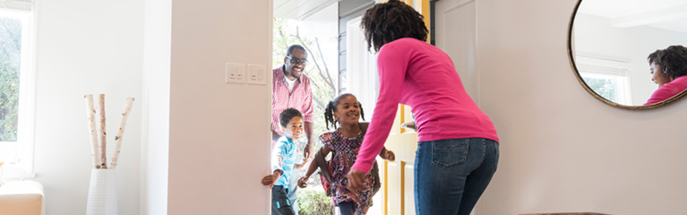 children coming home from school with dad, greeting mom