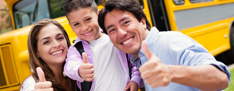 family in front of school bus