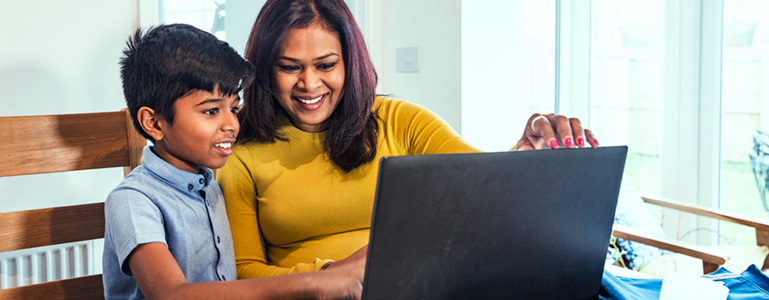 Mother and son looking at computer