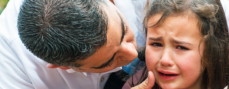 Dad comforting daughter