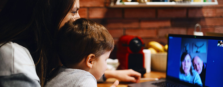 mom and son talking to grandparents on computer