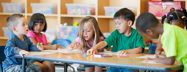 group of kids using crayons