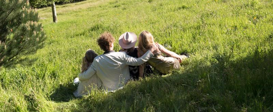 Family sitting in field