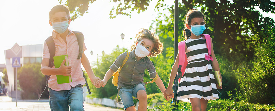 Kids in COVID masks walking to school