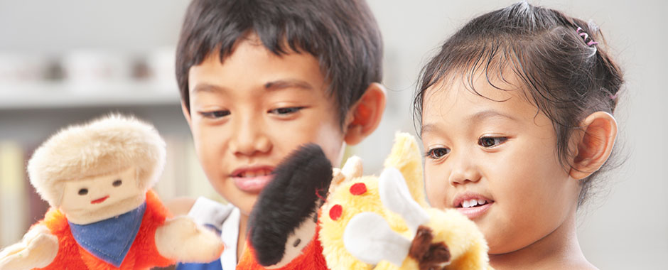 brother and sister playing with puppets