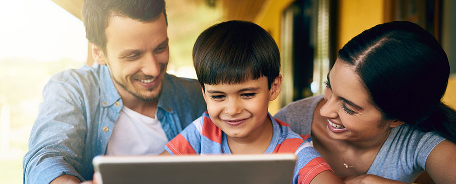 parents and child on tablet