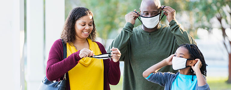 Family putting on masks