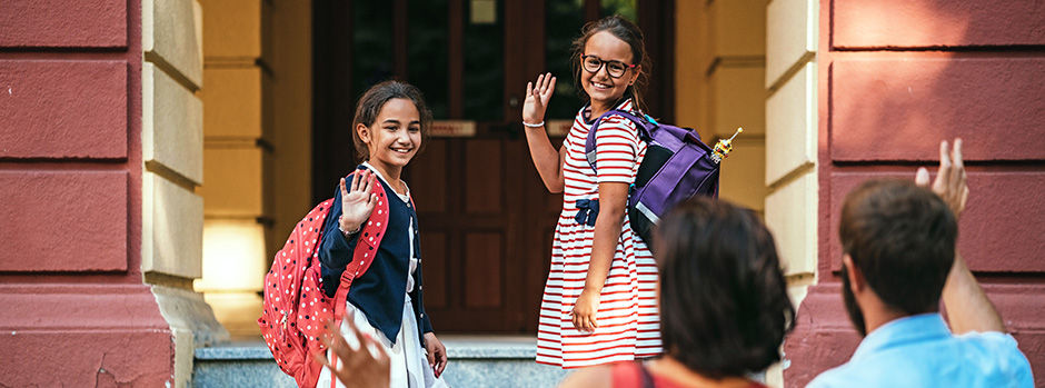 school girls waving to parents