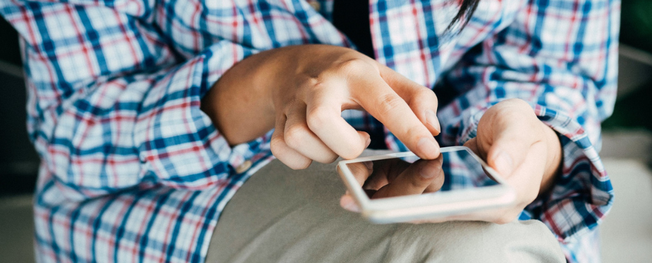 teen touching a smart phone